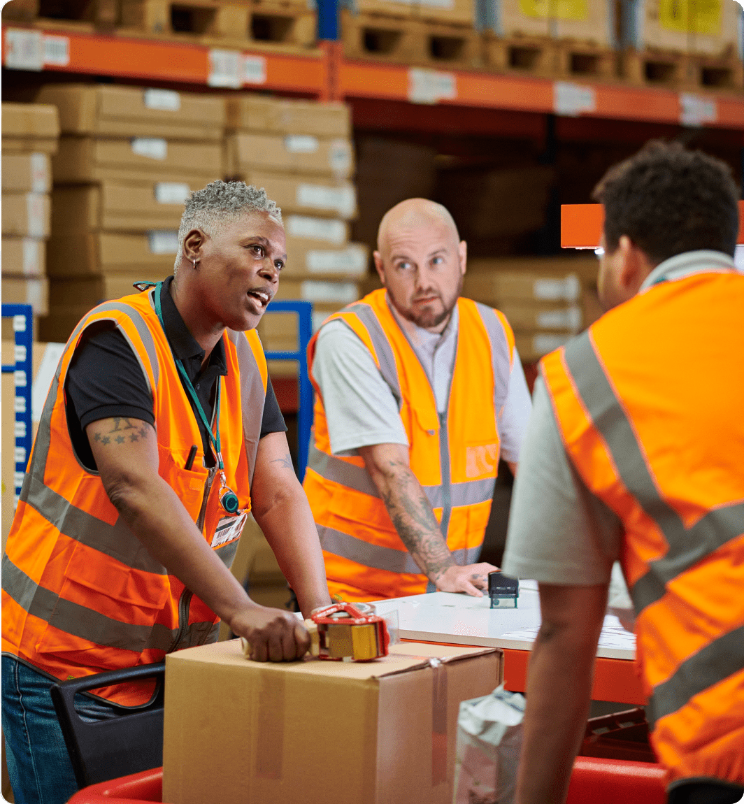 Workers in high-visibility vests talking