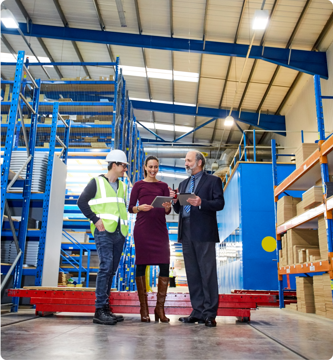 Workers reviewing documents in warehouse
