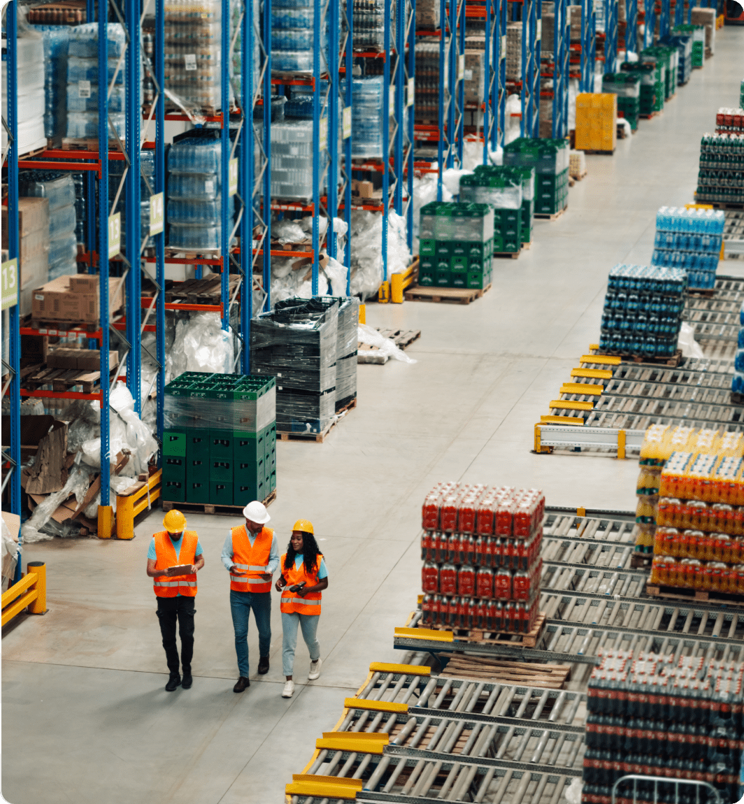 Employees in high-visibility vests in warehouse